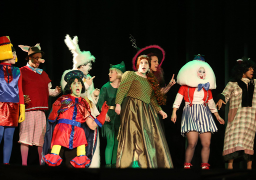 group in costumes singing a song during a theatre performance