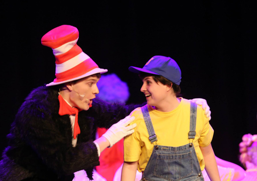 two people dressed in costume in the middle of a theatre performance looking into eachother's eyes excited